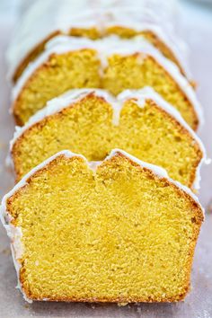 slices of lemon pound cake with icing sitting on a white surface next to each other