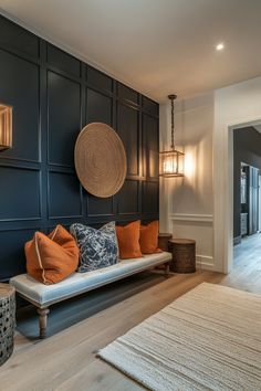 a living room filled with lots of furniture next to a wall mounted lamp and wooden flooring