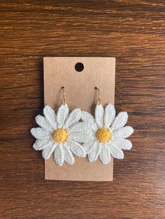 white crochet flower earrings with yellow centers