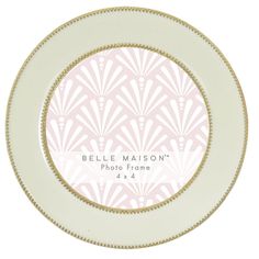 a white and gold plate with an art deco design on the rim that reads, belle maison'photo frame 4x4