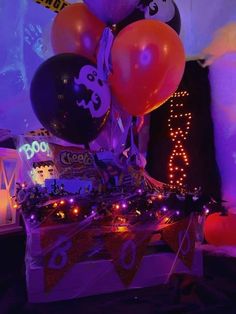 a birthday cake with balloons and decorations on it