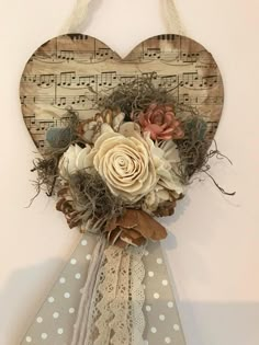 a heart shaped wall decoration with flowers and music notes