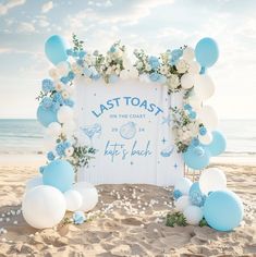 a sign that says last toast on the beach with blue and white balloons around it