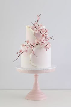 there is a white cake with pink flowers on it