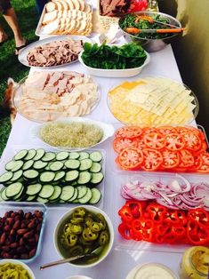 a table topped with lots of different types of food next to bowls and plates filled with vegetables