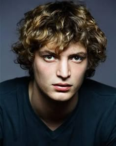 a black and white photo of a man with curly hair