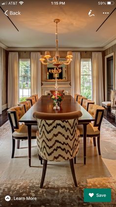 a dining room table with chairs and a chandelier