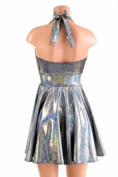 "This item is made to order, please read all the way through the listing before purchasing! This flowy dress is made of beautiful silver holographic spandex. The halter top is darted and ties behind the neck, the hemline is circle cut. Length: 17\" measured from the waist to the hemline. We can create this dress from any other fabric in our shop, just ask! Womens Sizing (See below for instructions on where measurements should be taken) XXS: Bust 29\"-30\" / Waist 22\"-23\" / Hips 30\"-32\" Extra Fitted Sleeveless Shiny Dress, Shiny Backless Summer Dresses, Metallic Summer Dress, Shiny Fitted Backless Dress, Fitted Shiny Backless Dress, Metallic Shiny Summer Dress, Metallic Backless Dress, Silver Halter Neck Dress For Summer, Metallic Halter Neck Dress For Summer