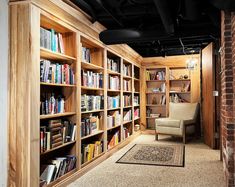 an empty library with lots of bookshelves and a rug on the floor in front of it