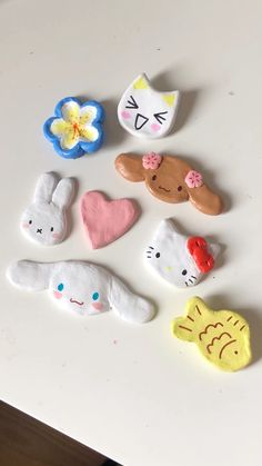 several different shaped cookies sitting on top of a white table next to flowers and hearts