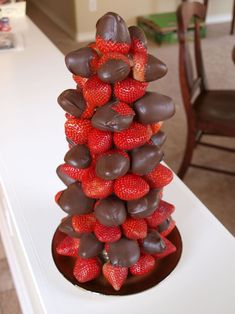 chocolate covered strawberries stacked on top of each other in the shape of a tower