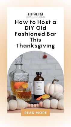 a bottle of alcohol sitting on top of a table next to pumpkins and other items