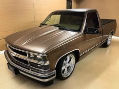 a brown truck parked in a garage next to a wall