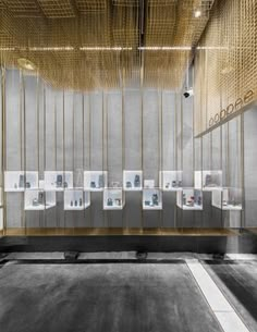 a room filled with lots of framed pictures and wooden slats hanging from the ceiling