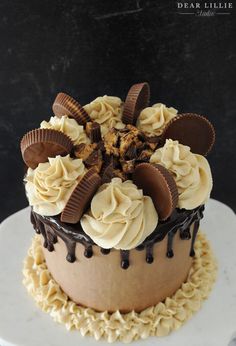 a chocolate cake with white frosting and cookies on top