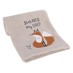 a baby blanket with an embroidered fox on the front and words that say stay wild, my child