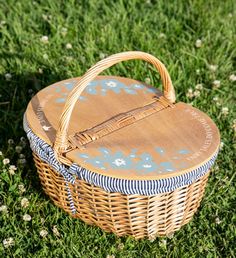 a wicker basket sitting on top of a lush green field