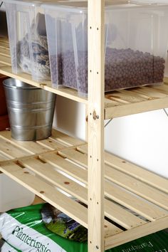 the shelves have plastic bins on them and are full of food, including nuts