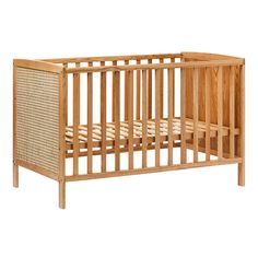 a wooden crib with wicker bedding on the bottom and sides, against a white background