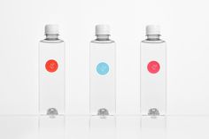 three water bottles with different colored labels on them