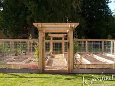 an outdoor vegetable garden with fenced in area