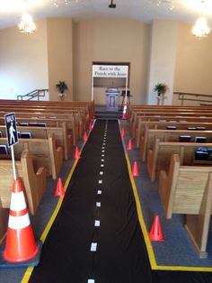 an empty church with rows of pews and orange cones