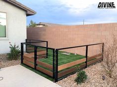 a fenced in yard with artificial grass on the ground and steps leading up to it