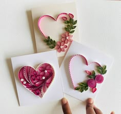 three cards with flowers and hearts made out of paper on top of a white surface