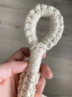 someone is holding up a white rope that looks like an o - ring for the camera