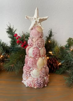 a christmas tree made out of seashells and pine cones