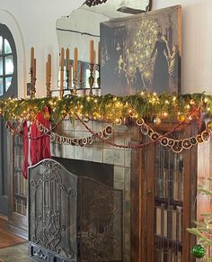 a fireplace decorated with christmas lights and garland