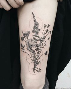 a woman's arm with flowers and geometric shapes on the back of her body