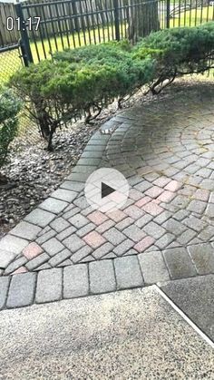 an image of a brick walkway in the middle of a park with trees and bushes