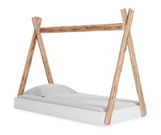 a white bed with wooden posts on the headboard