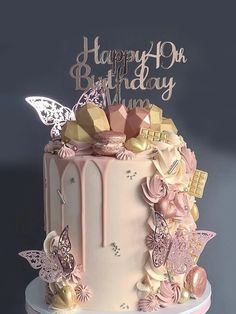 a birthday cake decorated with pink and gold decorations