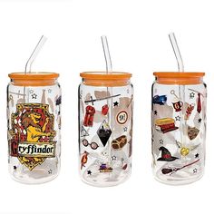 three harry potter mason jars with lids and straws on the lids are decorated with hogwart's symbols