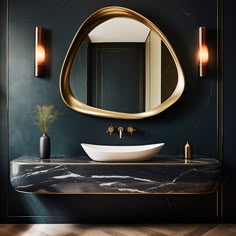 a bathroom with a sink, mirror and lights on the wall in front of it