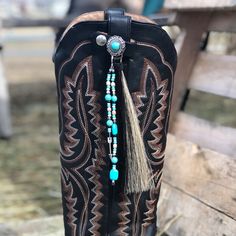 Add some flair to your boots with our Horsehair Boot Tassel! A silver scalloped concho adorned with authentic horse hair and colorful beads will make you stand out. Plus, the leather snap closure makes it easy to secure onto any boot strap. Elevate your style with this cute accessory. This is a set for left and right boots. Available in 2 different styles and color combinations. Horsehair Boot Tassel is sold individually. Horsehair is 6" long. Seed Bead Jewelry Patterns, Weekend Travel Bags, Handmade Jewelry Bracelets, Boot Straps, Wallet Gifts, Boot Accessories, Horse Hair, Seed Bead Jewelry, Western Boots