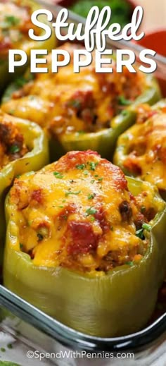 stuffed peppers in a baking dish with cheese on top and green peppers around the edges