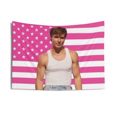 a man standing in front of a pink and white american flag wall hanging on a wall