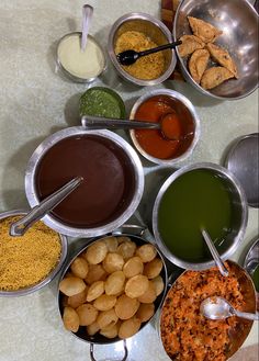 several bowls filled with different types of food