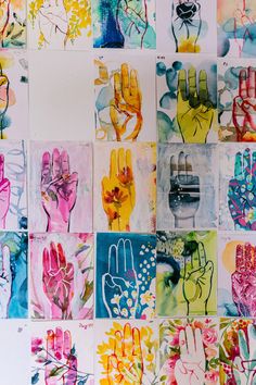 many different colored hand prints on a wall