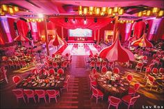 a banquet hall with tables and red chairs