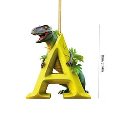 a dinosaur alphabet ornament hanging from a gold chain with the letter a on it