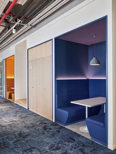 an empty room with blue and white booths