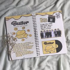 an open notebook with stickers on it sitting on top of a white bed sheet