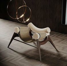 a chair that is sitting in the middle of a room with wood flooring and a circular light fixture