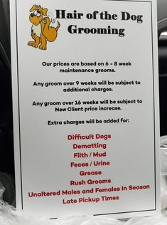 a sign on the back seat of a car warning people to keep their dogs from grooming