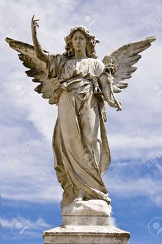 an angel statue is shown against a blue sky