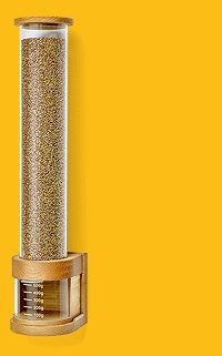 a bird feeder on a yellow background